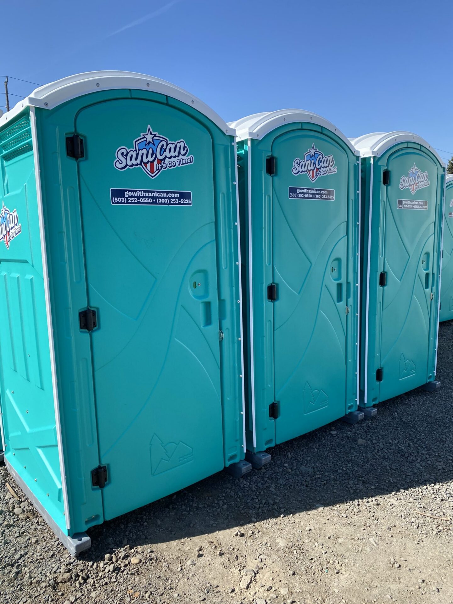 image of a row of three american sanican porta potties | porta potty rental vancouver salem portland oregon washington