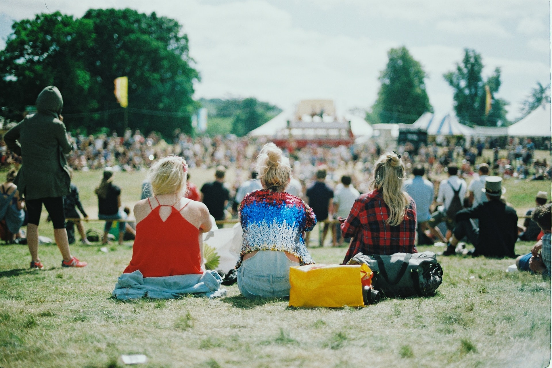 photo of people sitting down outside at festival | porta potty festivals outdoor events portland salem washinton oregon
