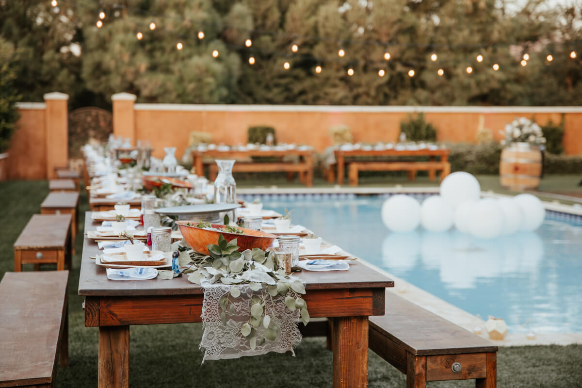 Rent a portable restroom for a backyard wedding - wedding with pool and long tables