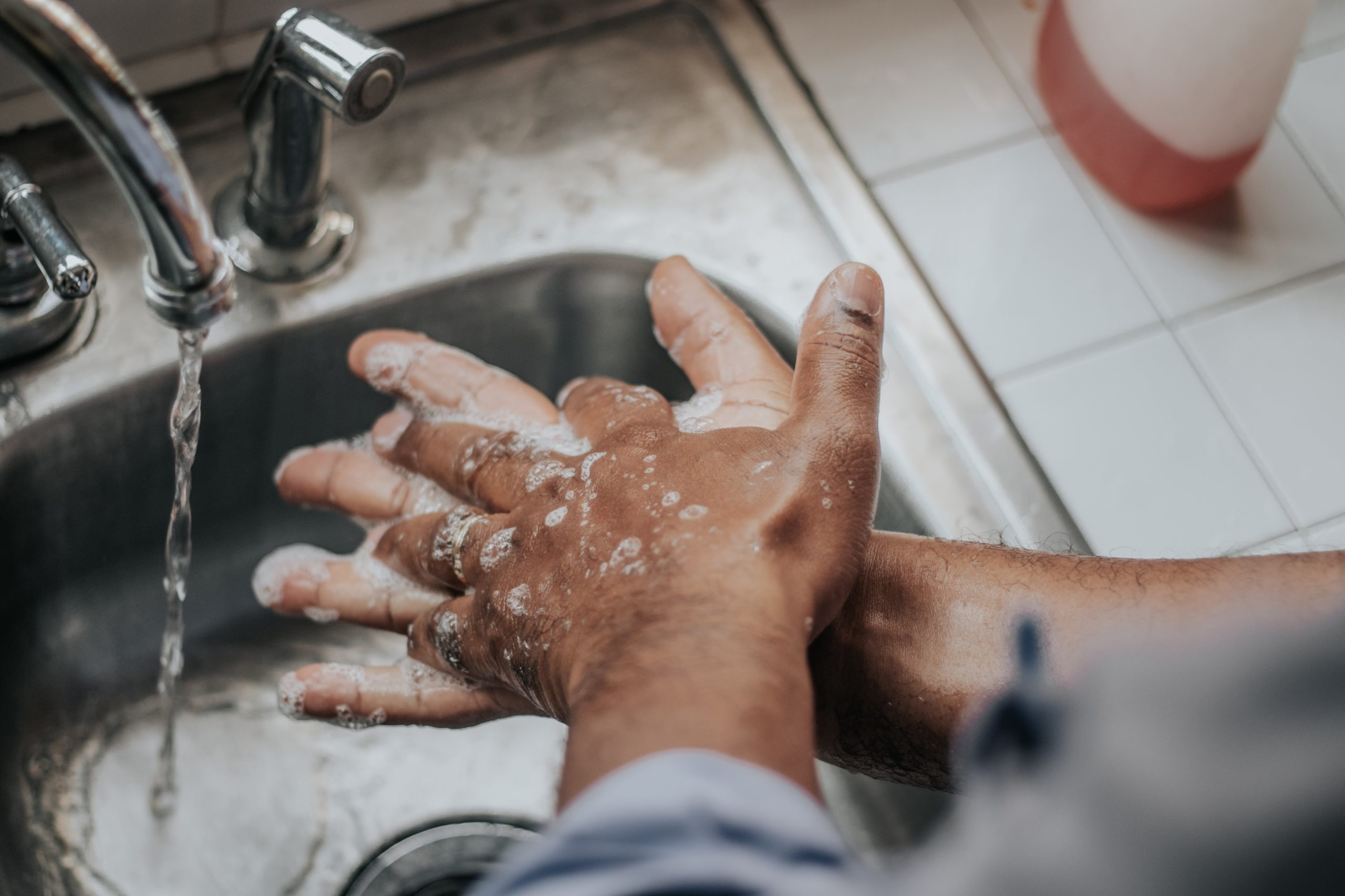melissa-jeanty-Ks4RTBgQ_64-unsplash image of someone washing hands in a sink | porta potty rental vancouver salem portland oregon washington
