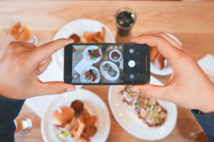 image of person taking a picture of food with a phone | Porta potty portable toilet rental portland oregon salem vancouver washington