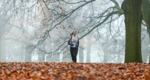 image of woman running in fall | portland marathon road races oregon salem vancouver